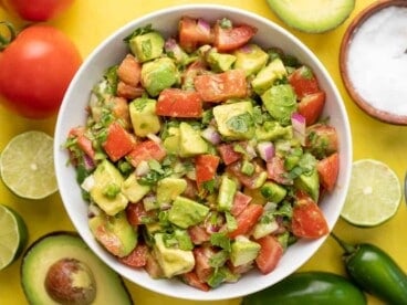Overhead view of a bowl full of avocado and tomato salad.