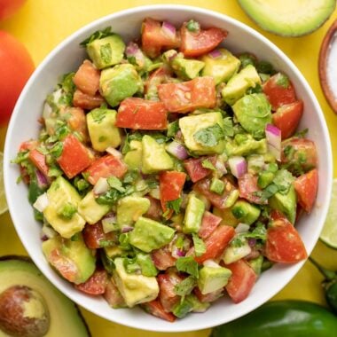 Overhead view of a bowl full of avocado and tomato salad.