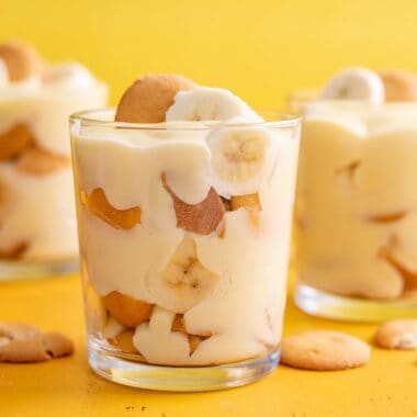 Side shot of three glasses of banana pudding.