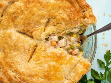 A slice of chicken pot pie taken out of the pie dish.