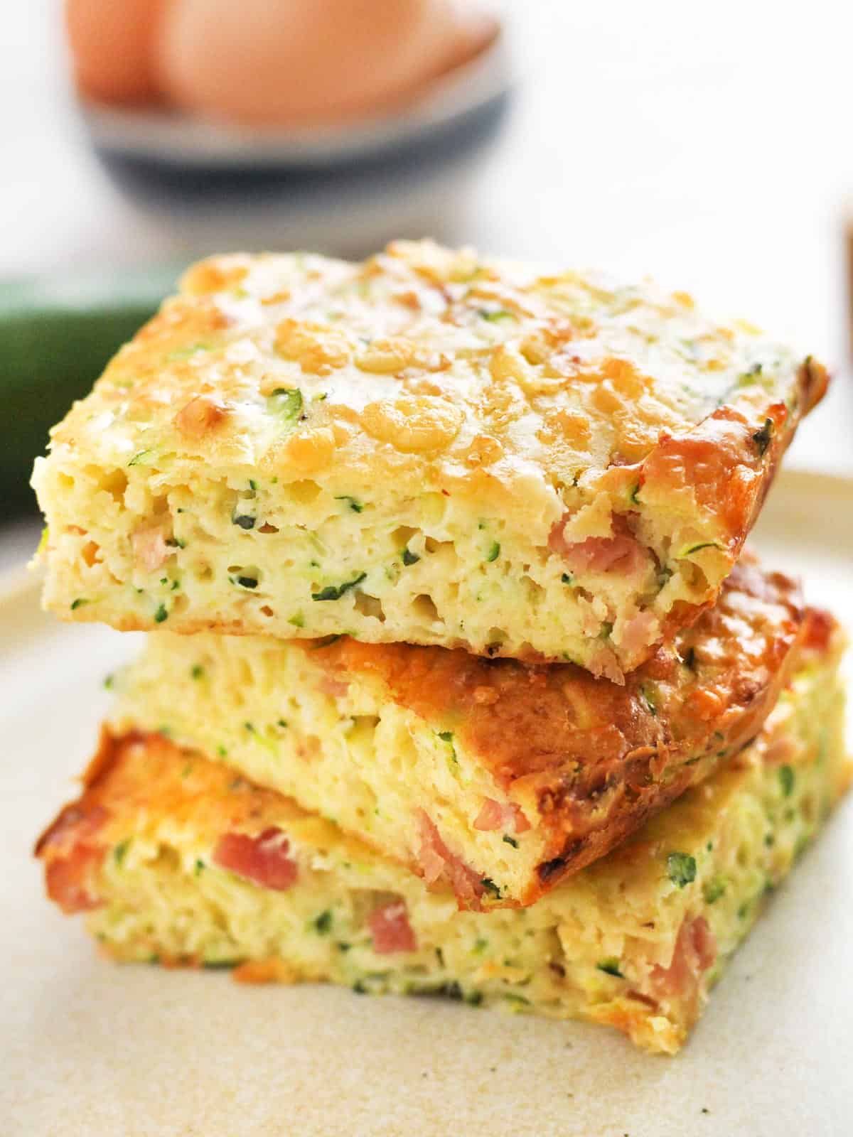 A stack of slices of zucchini slice on a plate.