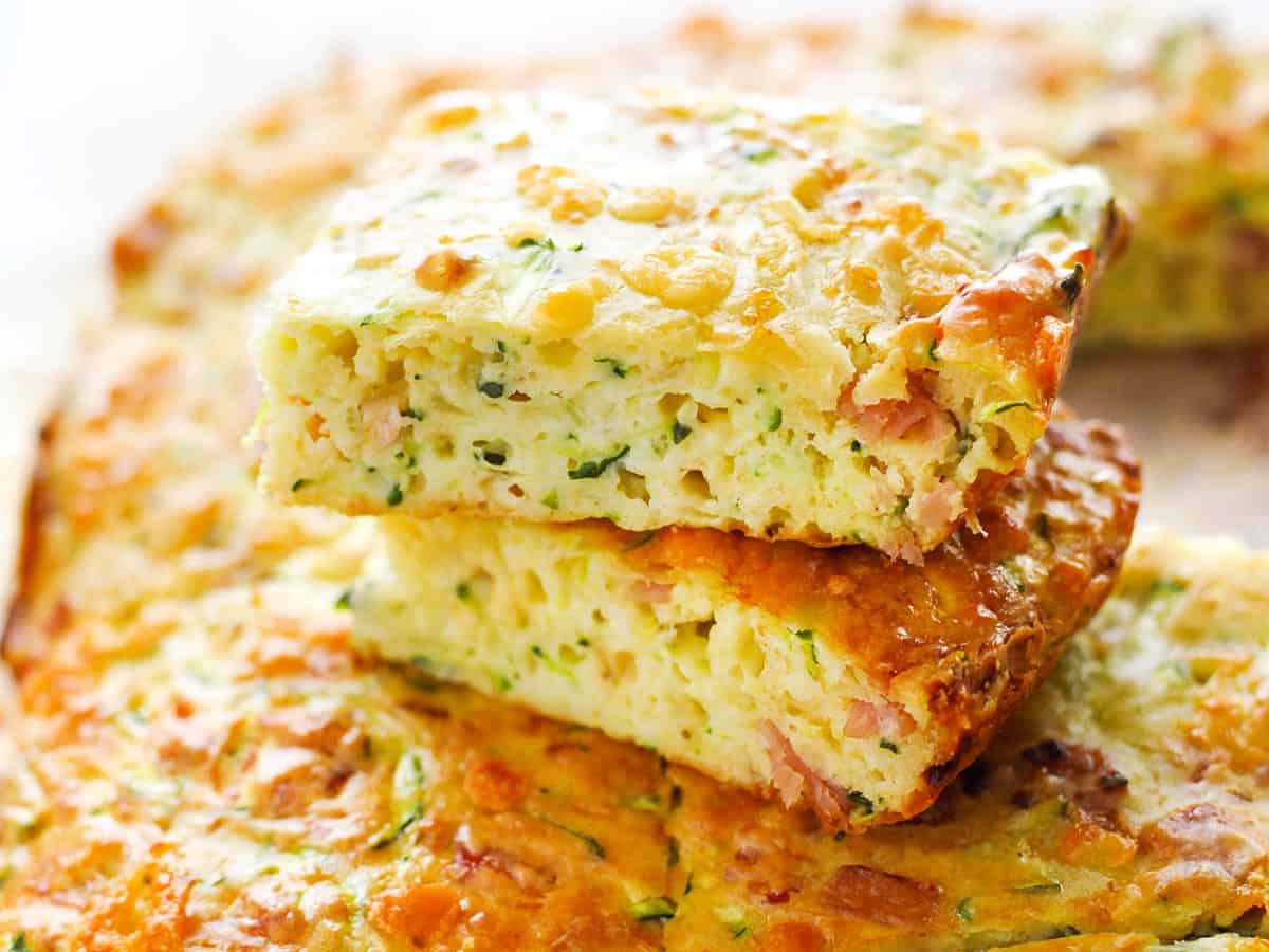 Two slices of Zucchini slice on top of the casserole.