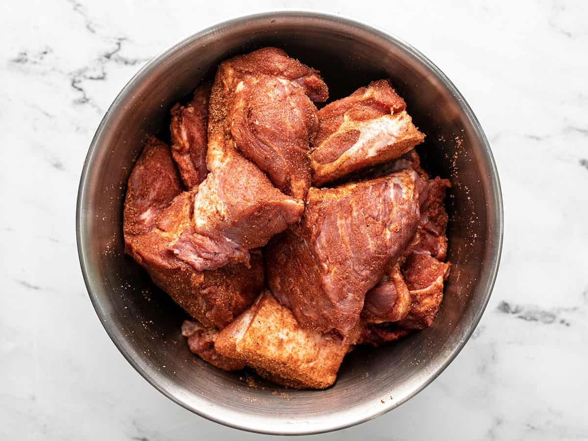Meat coated with spices in a bowl.