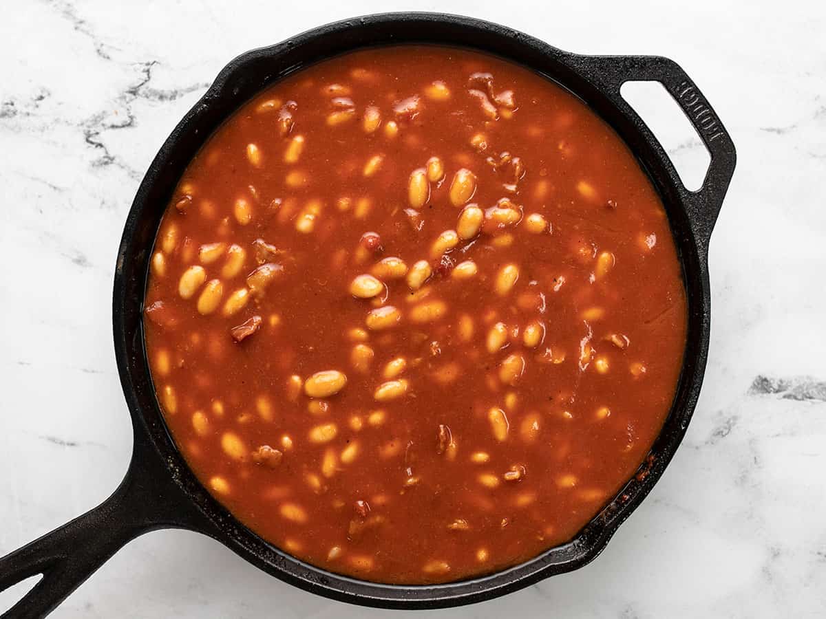 Baked beans in a skillet before going into the oven.