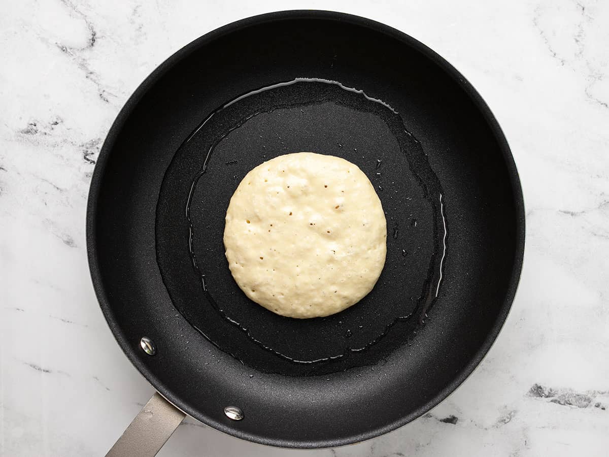 Overhead shot of pancake cooking in a pan.