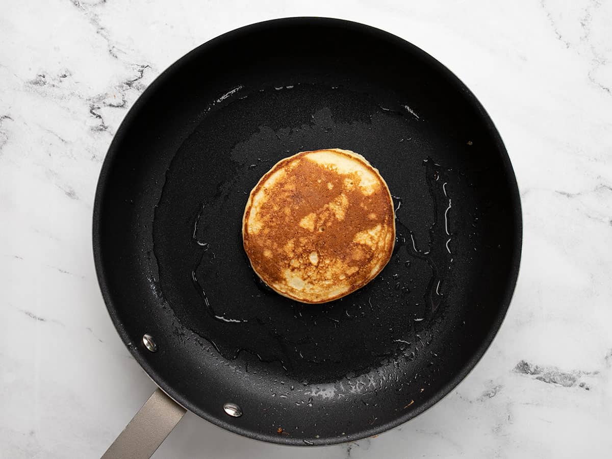 Overhead shot of cooked pancake in a pan.