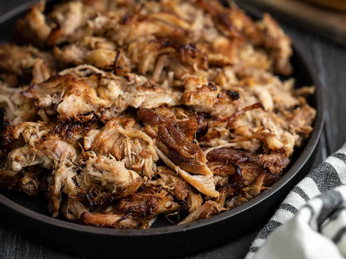 Close up side view of a plate full of slow cooker pulled pork.