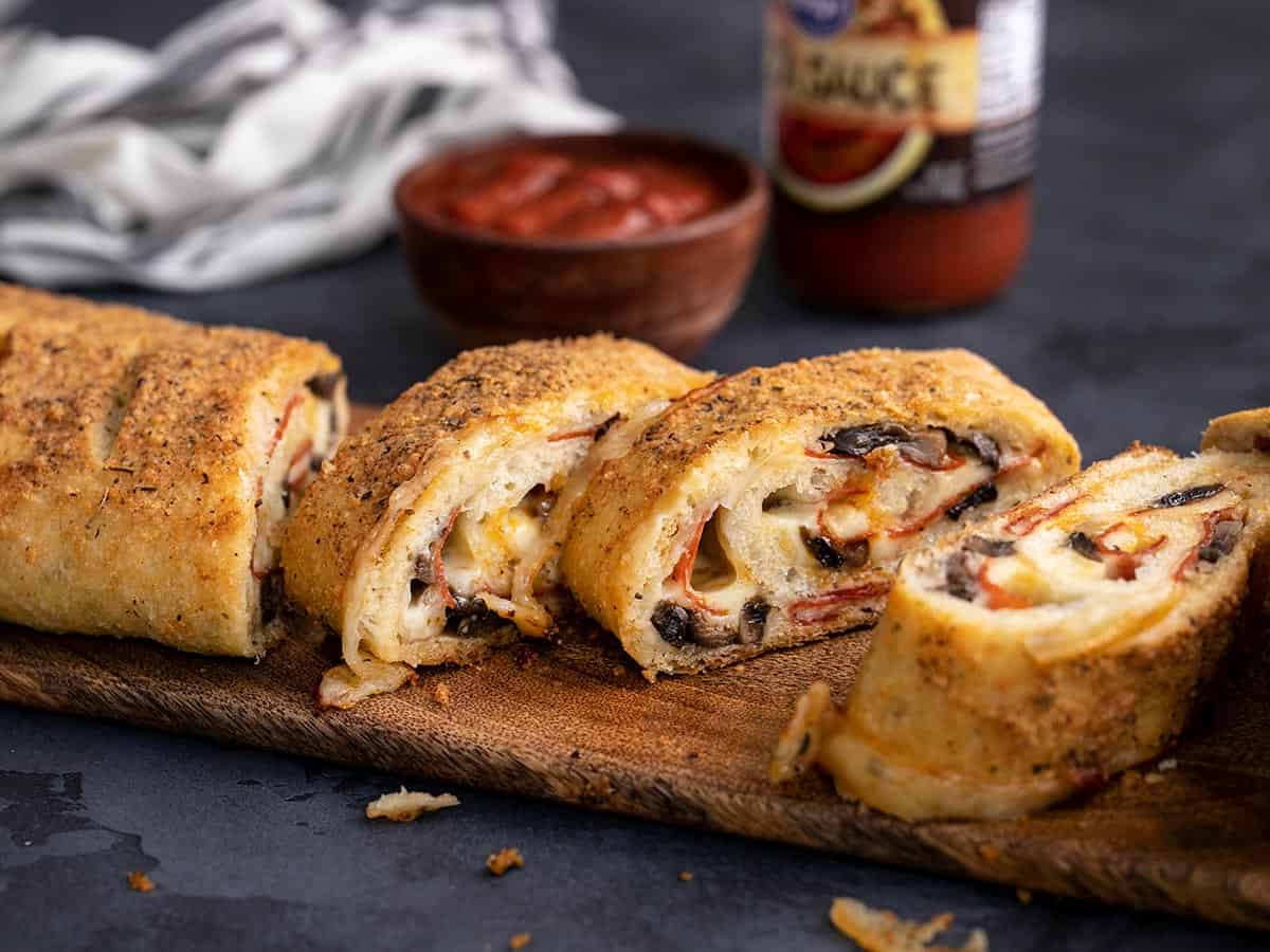 Side view of stromboli slices on a cutting board.