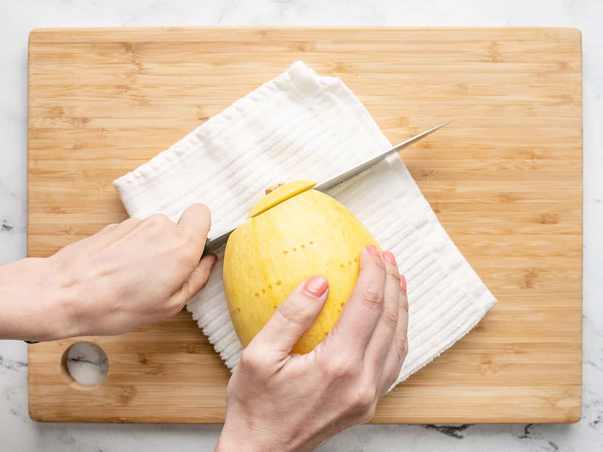 Overhead shot of knife cutting into spaghetti squash.