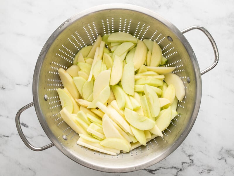 Overhead shot of apple in a colander.