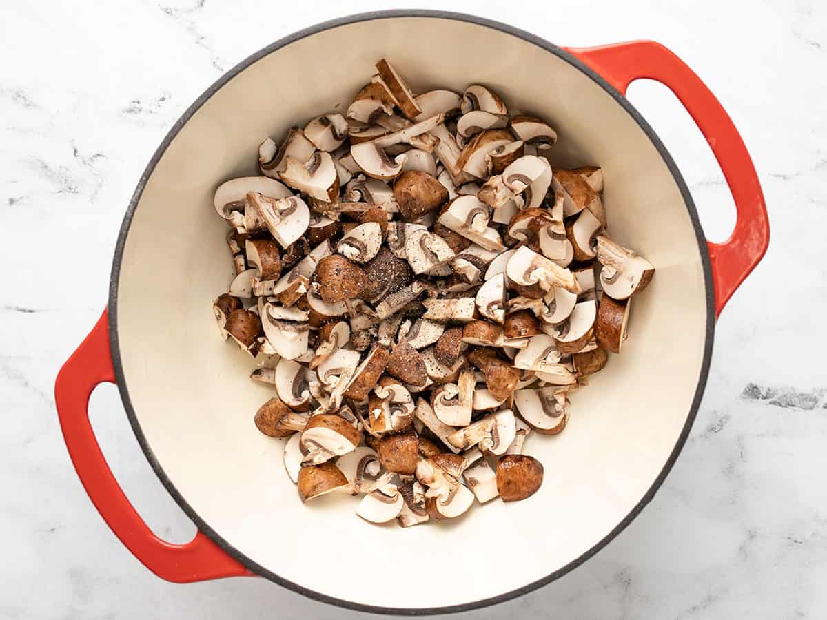 Sliced mushrooms in a soup pot.