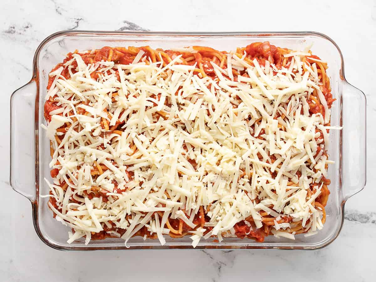 Second layer of pasta and shredded mozzarella in the casserole dish.