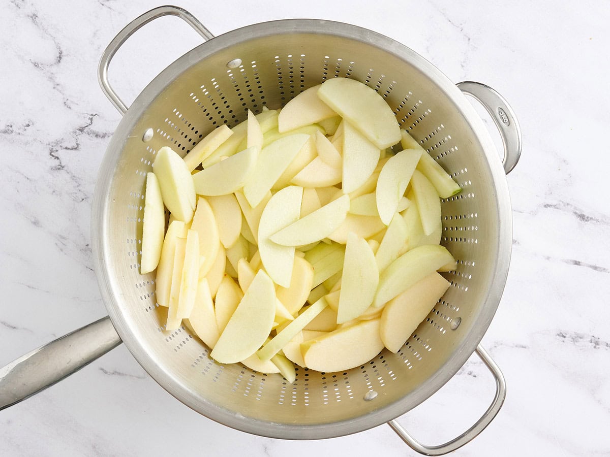 Apple slices in a colander.