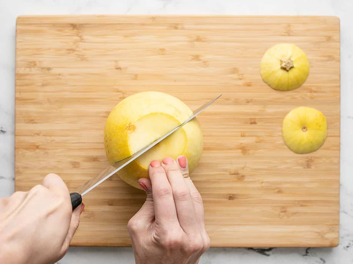 Overhead shot of knife cutting through spaghetti squash.