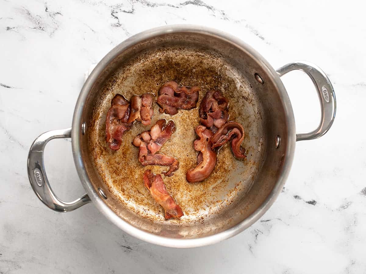 Browned bacon in a soup pot.