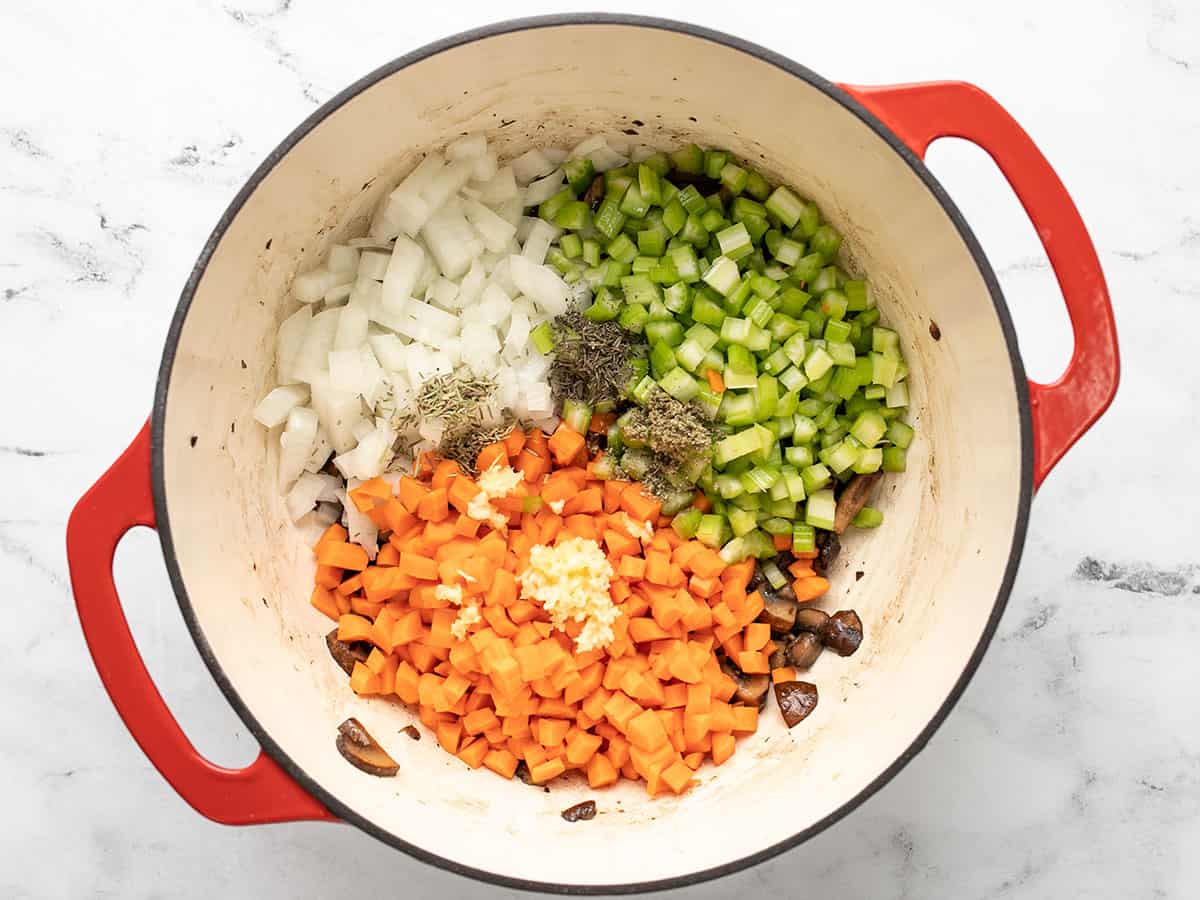 Chopped vegetables added to the pot.