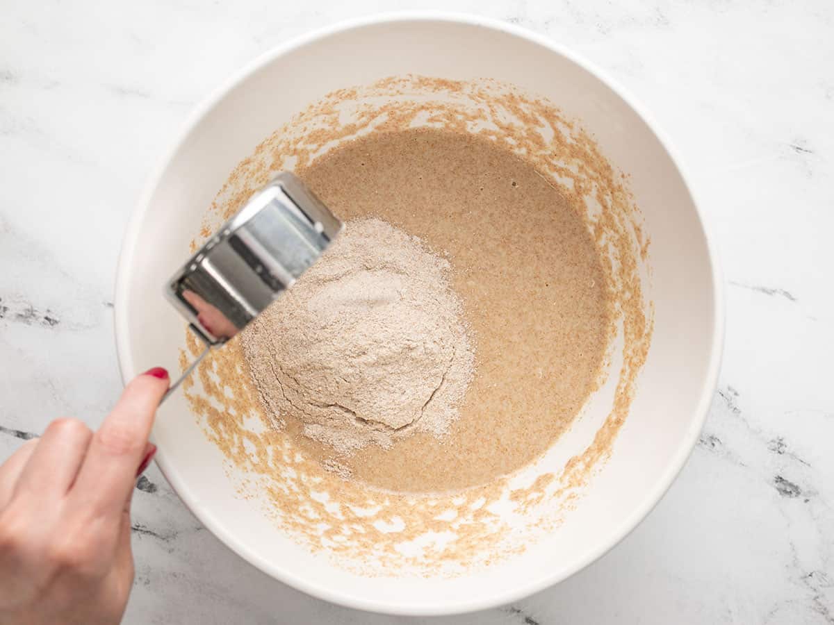 More whole wheat flour being added to the dough.