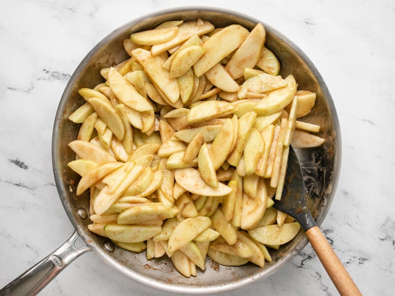 Overhead shot of apples cooking with caramel.