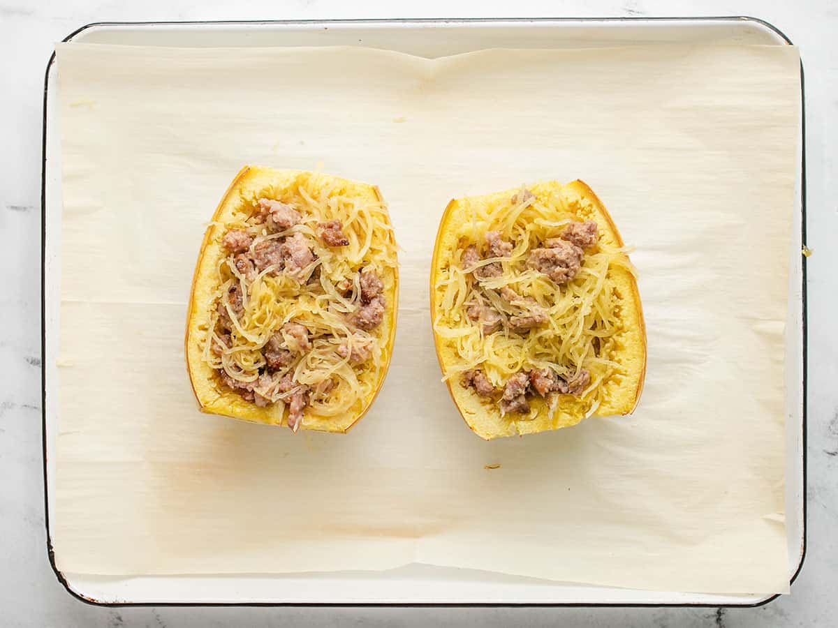 Overhead shot of stuffed spaghetti squash with sausage mixed with the squash.
