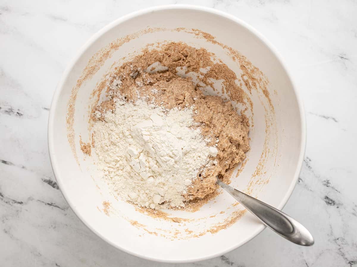 all purpose flour being stirred into the dough.