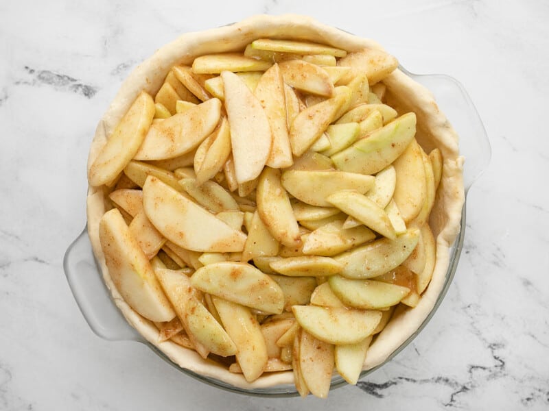 Overhead shot of sliced apples in pie shell.