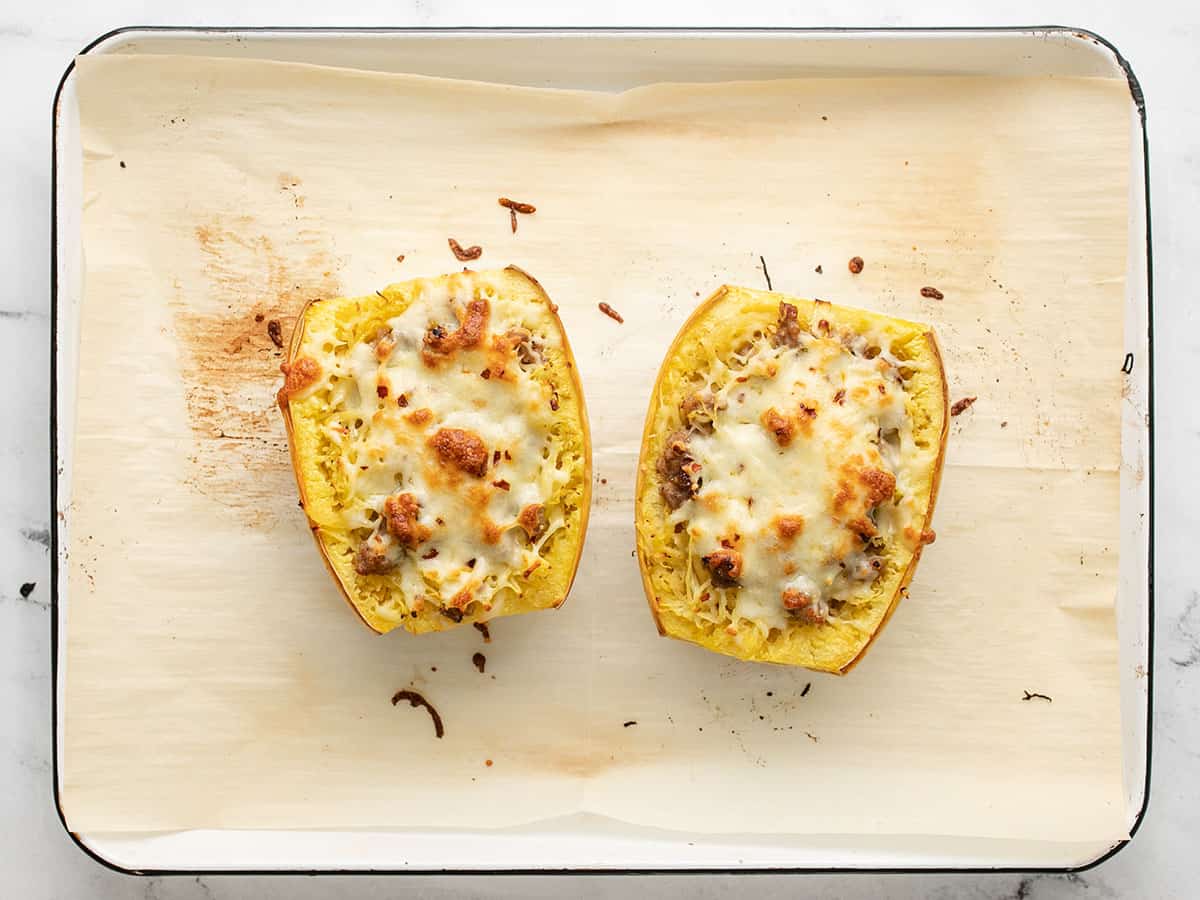 Overhead shot of stuffed spaghetti squash on a sheet pan.