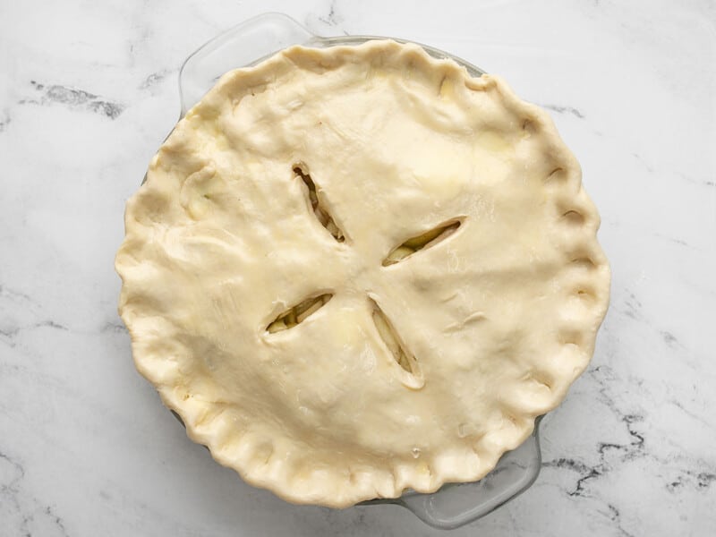 Overhead of raw pie with steam vents on it.