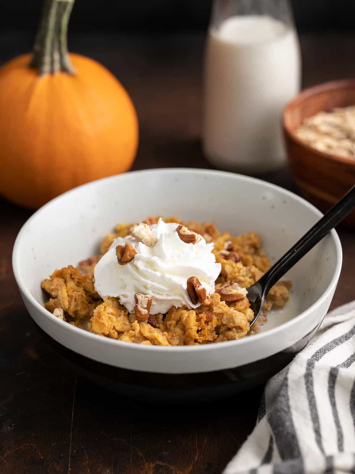 side view of a bowl of baked pumpkin pie oatmeal.