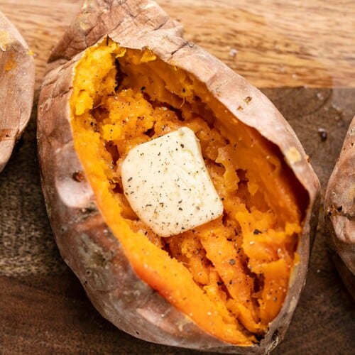 close up of a baked sweet potato with butter.