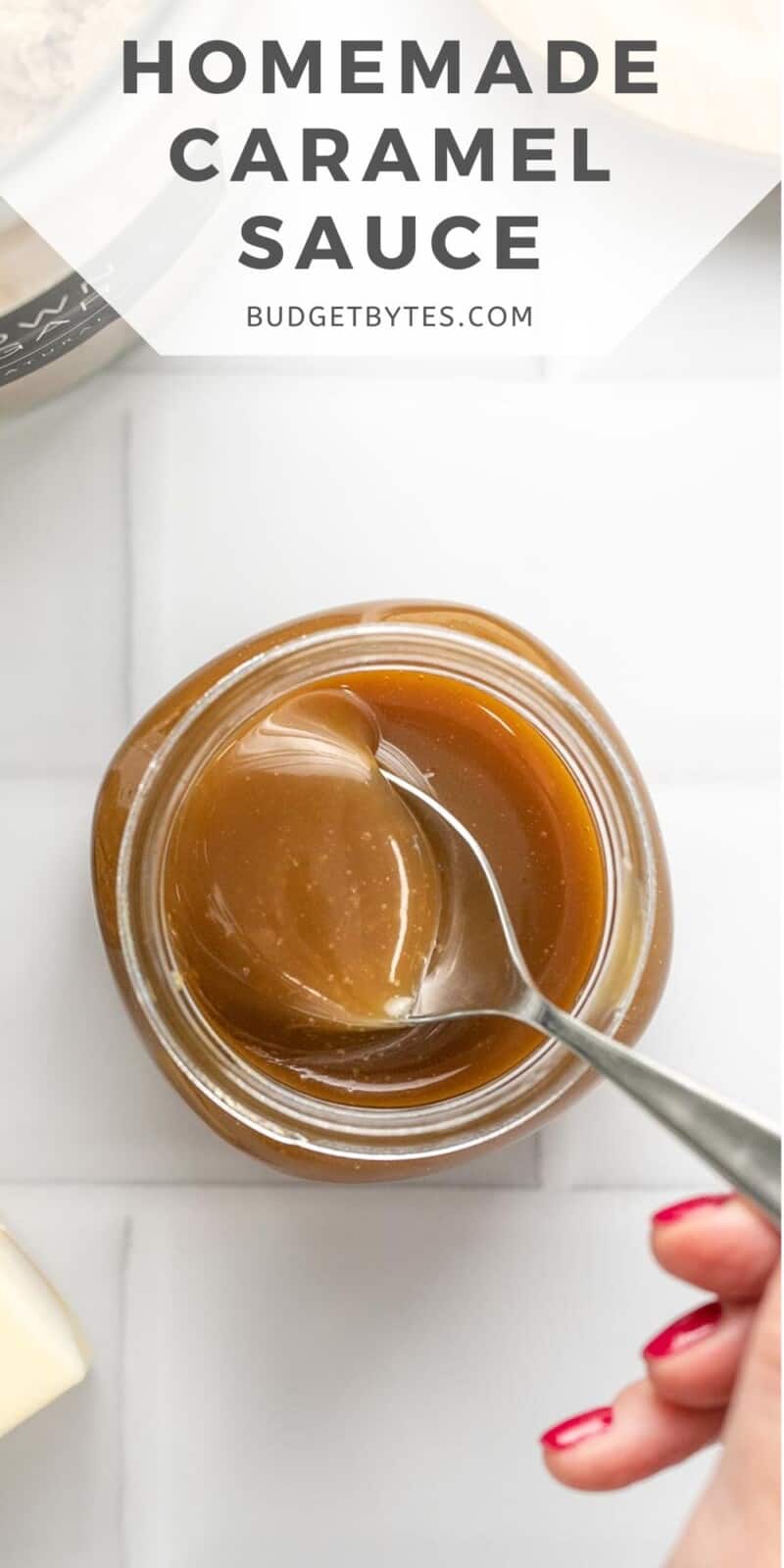 Overhead shot of a spoon taking caranel sauce out of a mason jar.