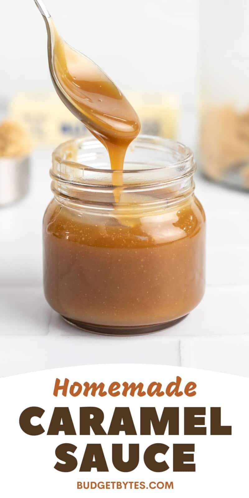 Side shot of a spoon drizzling caramel sauce in a mason jar.