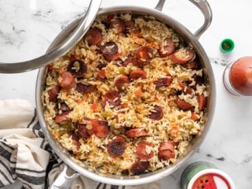 Overhead view of sausage and rice in the skillet.