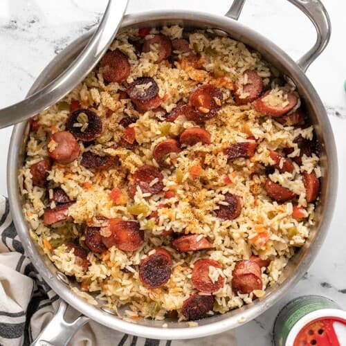 Overhead view of sausage and rice in the skillet.