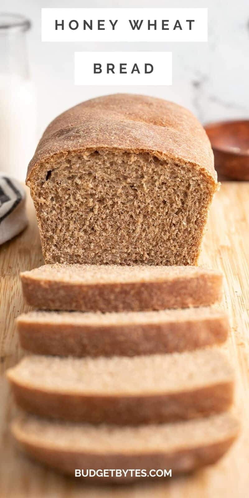 Front view of a loaf of sliced honey wheat bread.
