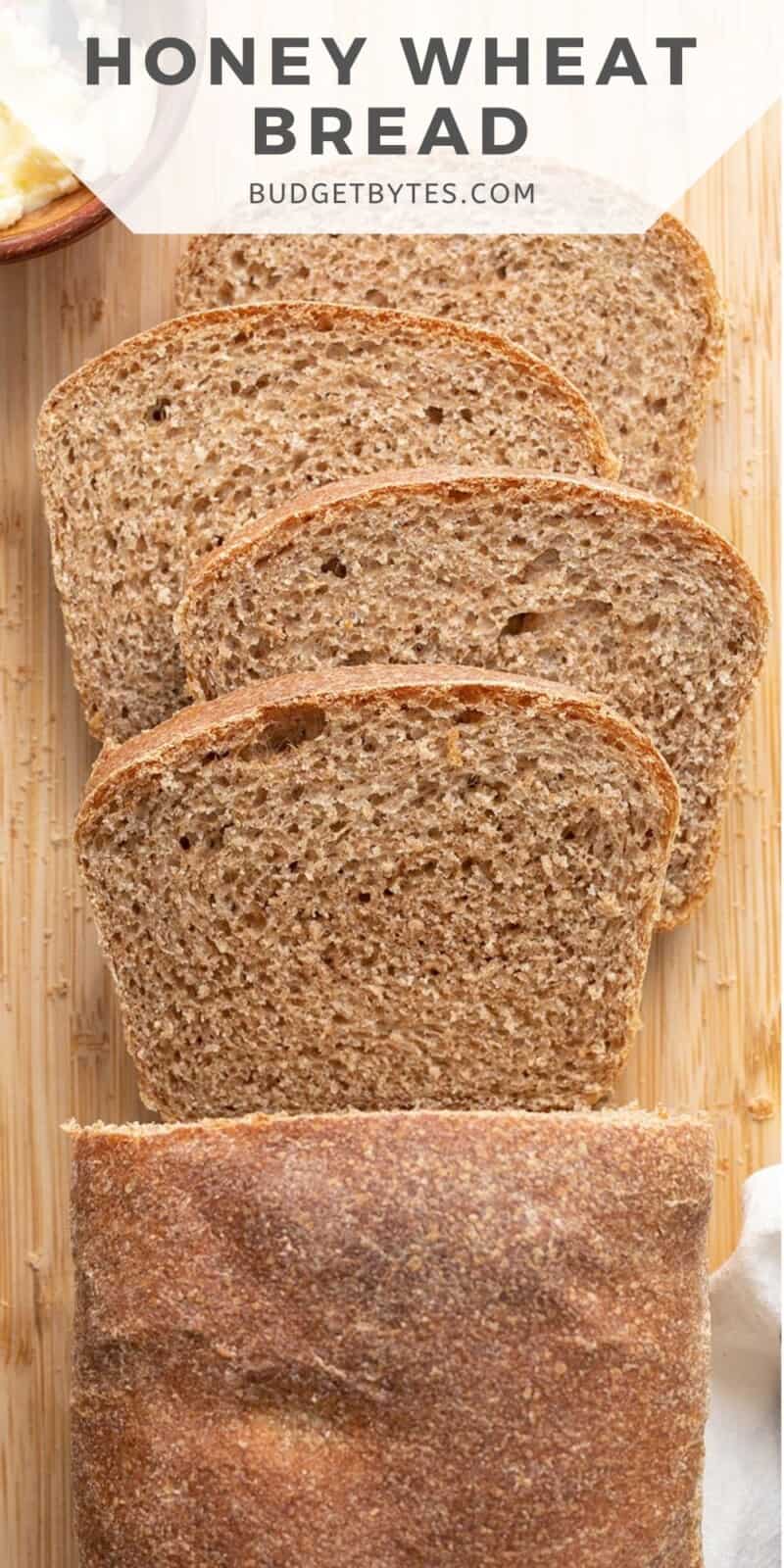 Overhead view of a sliced loaf of honey wheat bread.
