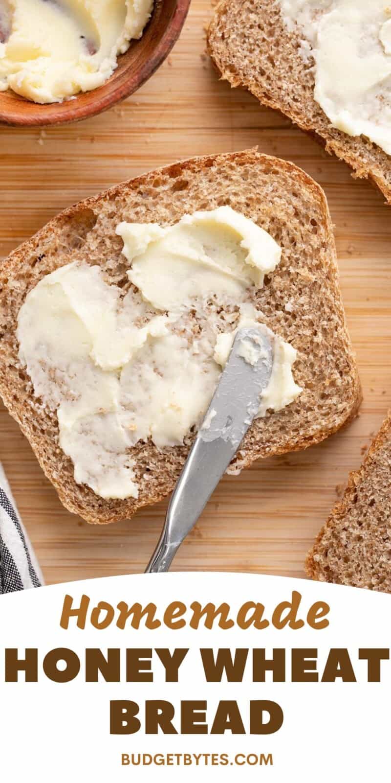 Overhead view of slices of honey wheat bread being smeared with butter.