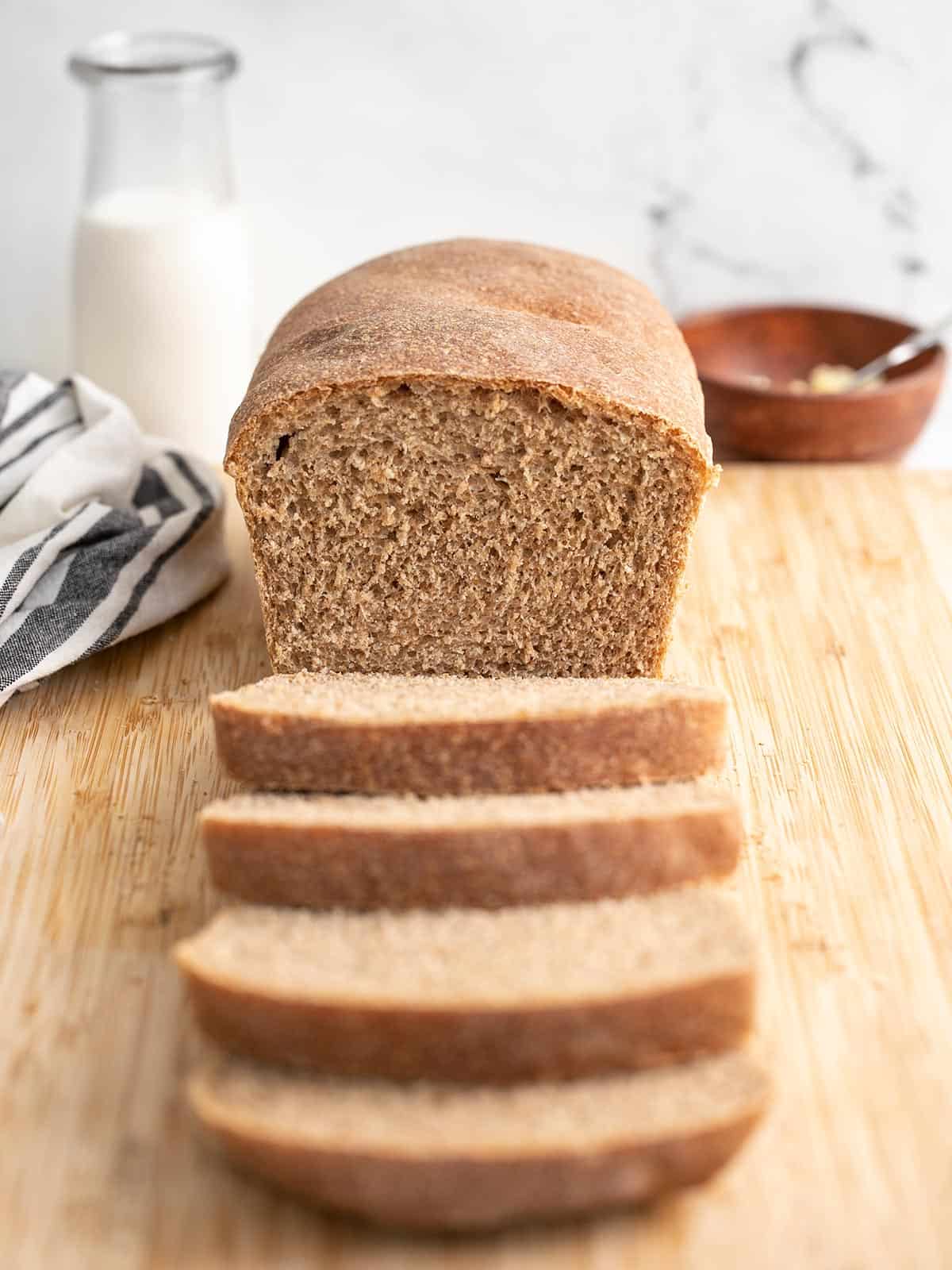 Front view of a loaf of honey wheat bread sliced.