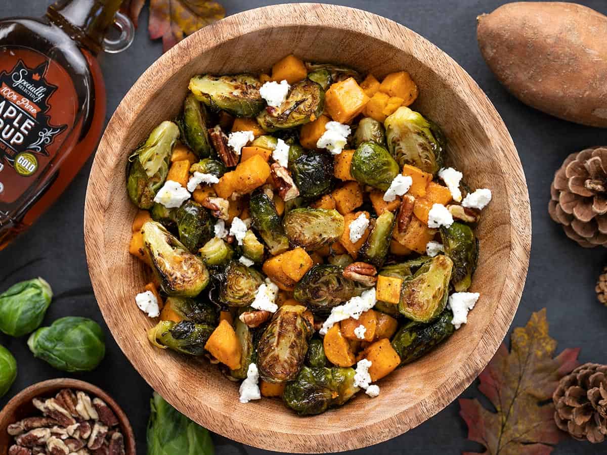 Overhead view of a bowl of Roasted Brussels Sprouts salad with ingredients on the sides.