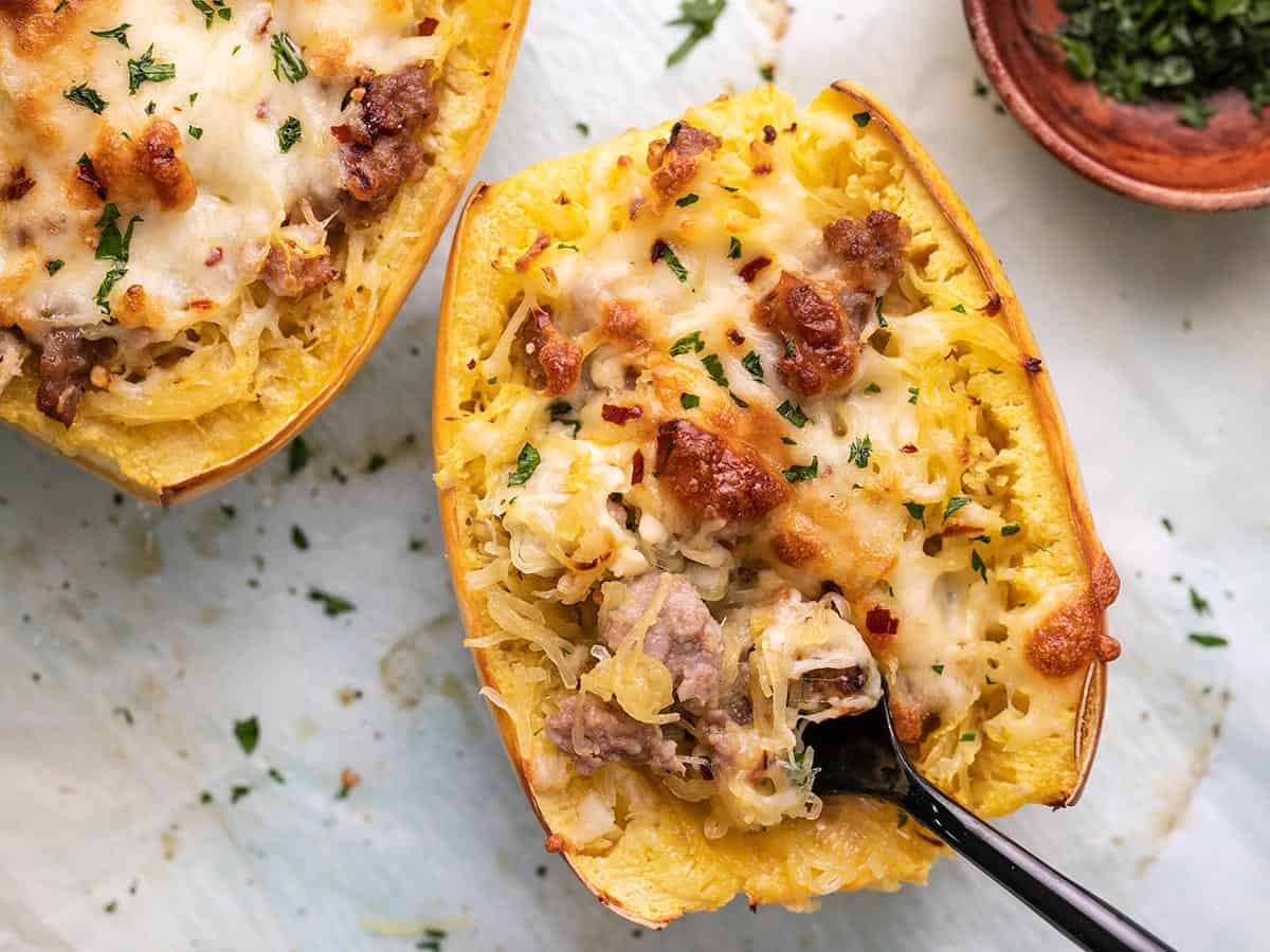 Overhead shot of stuffed spaghetti squash with a black fork in it.