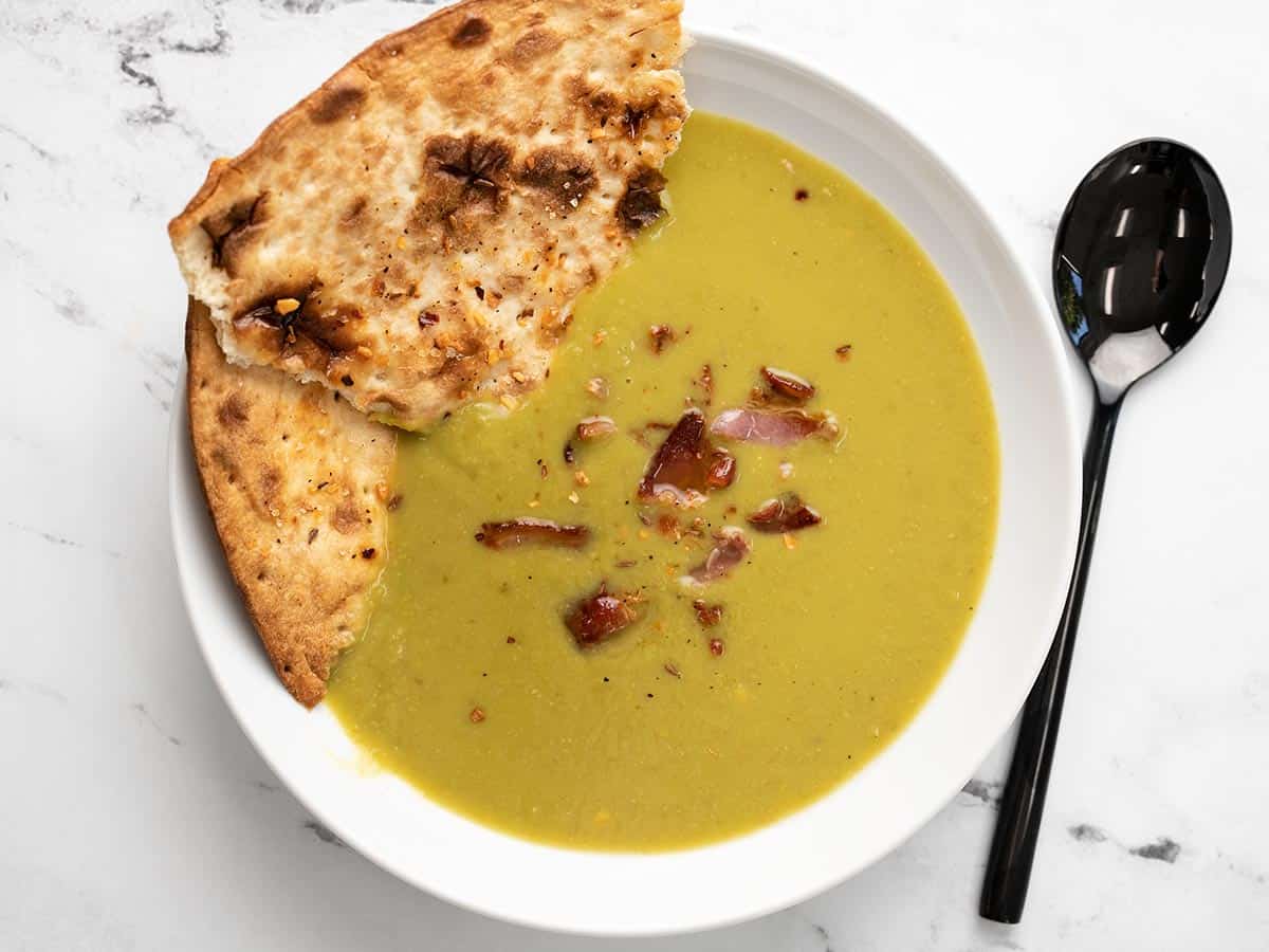 Served split pea soup with flatbread and topped with bacon.