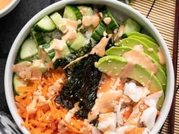 Close up overhead view of a sushi bowl with sriracha mayo.