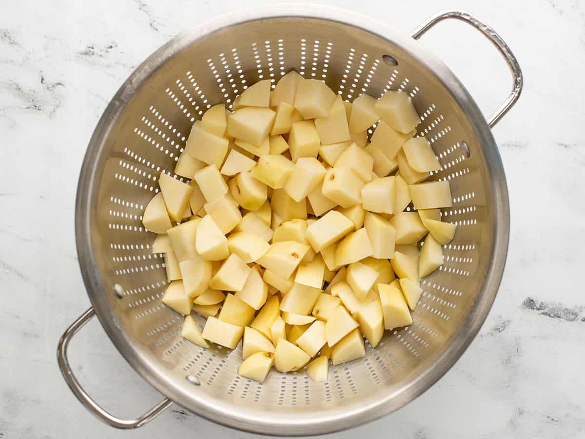 Diced potatoes in a colander.