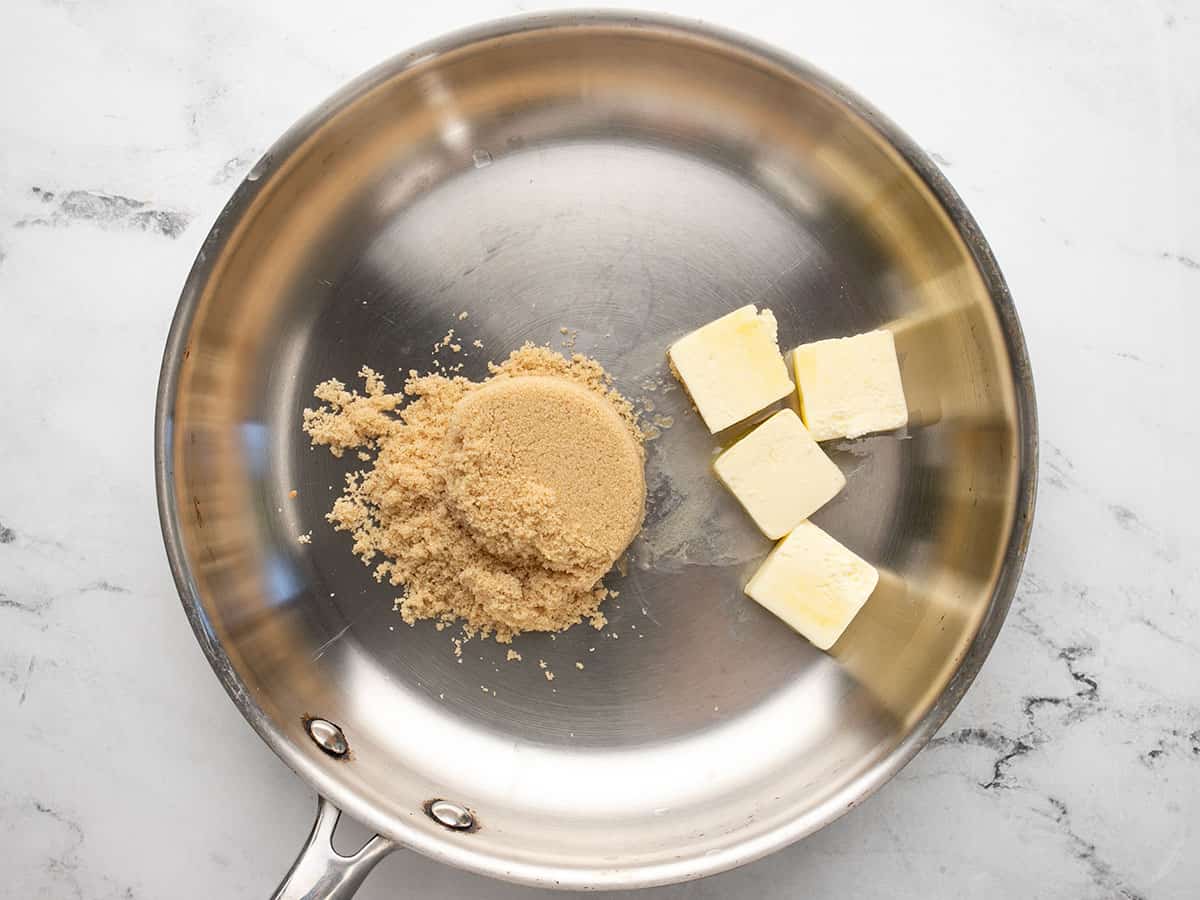 Overhead shot of brown sugar and butter in a silver pan.