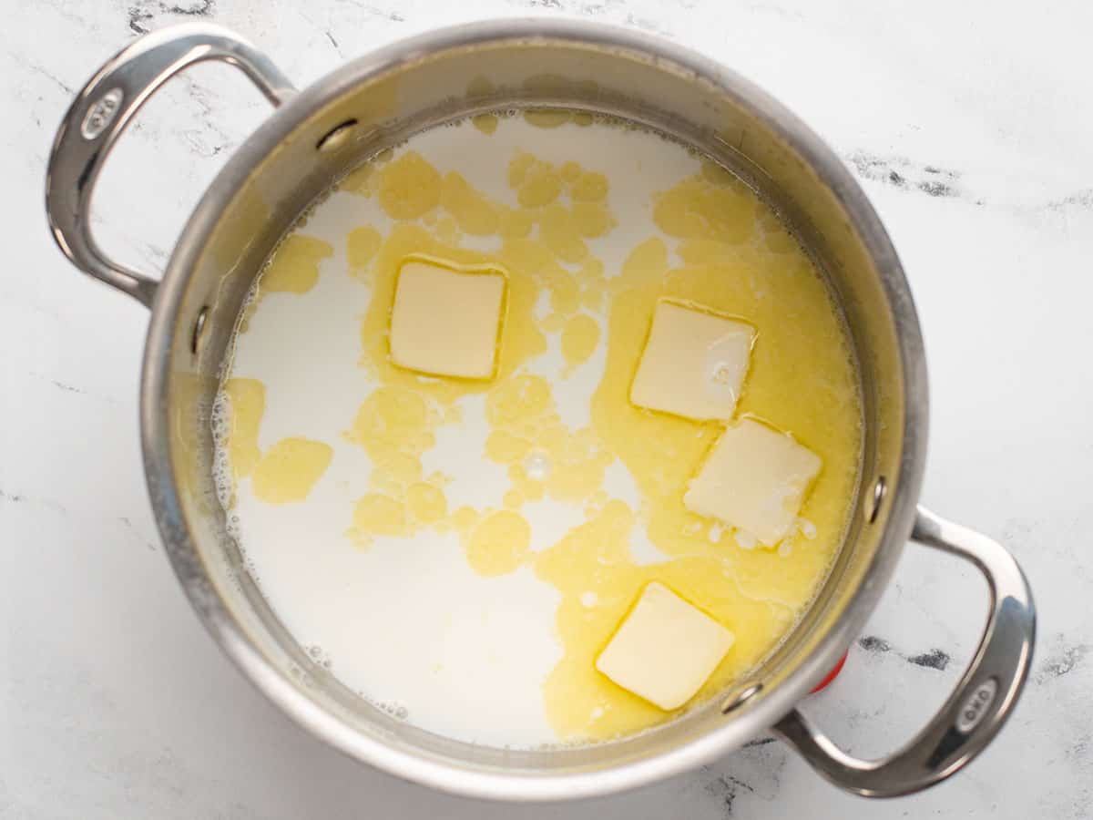 Butter and milk in the pot, butter melting.