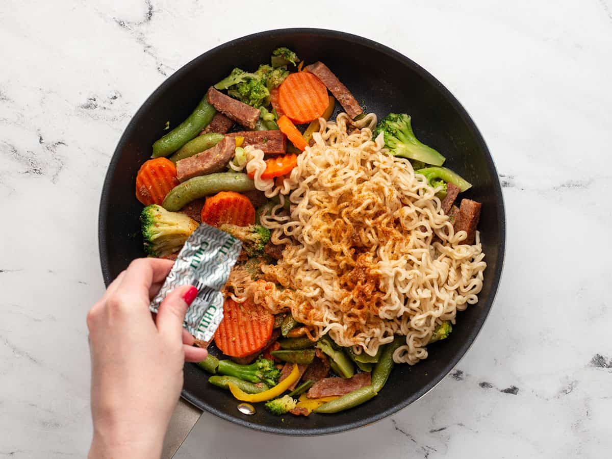 Noodles and seasoning added to the skillet.