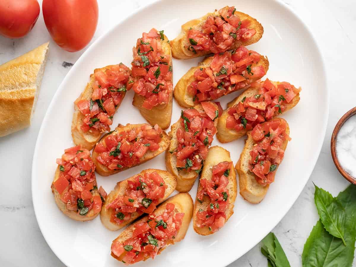 Overhead shot of white platter with bruschetta on it.