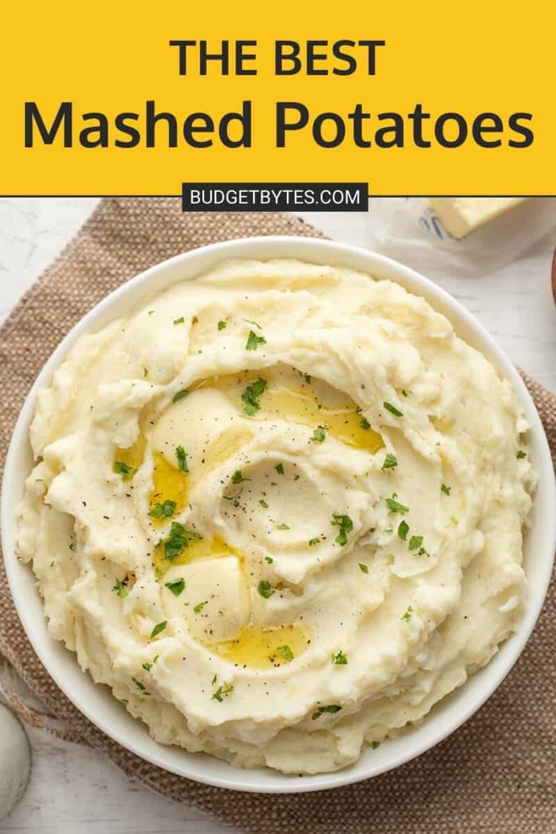 Overhead view of a bowl of mashed potatoes with melting butter.