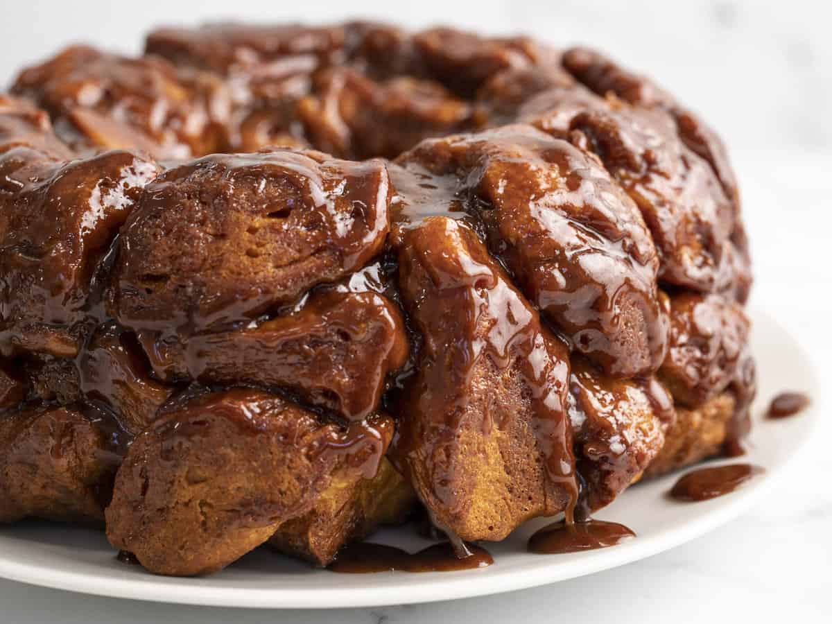 Side shot of Monkey Bread on a white plate.