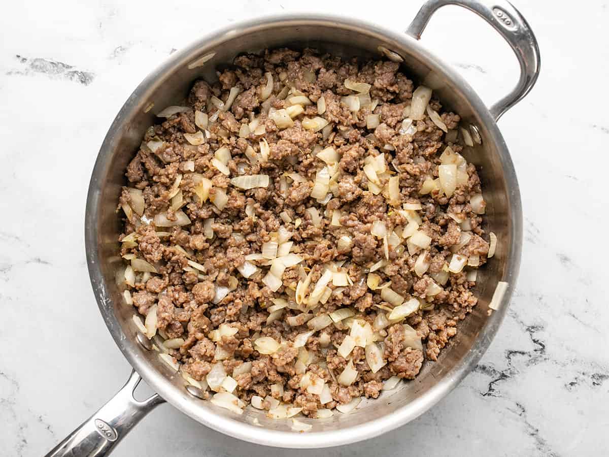 Browned sausage and onions in a deep skillet. 