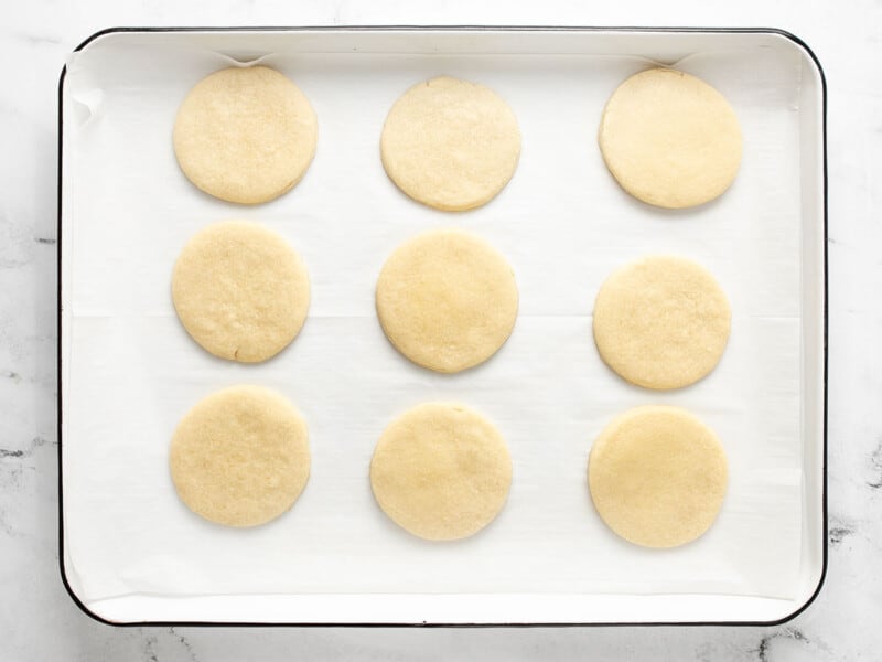 Overhead shot of baked sugar cookies in a sheet pan.